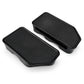 A pair of black plastic footrests with textured tops, shown on a clean white background.