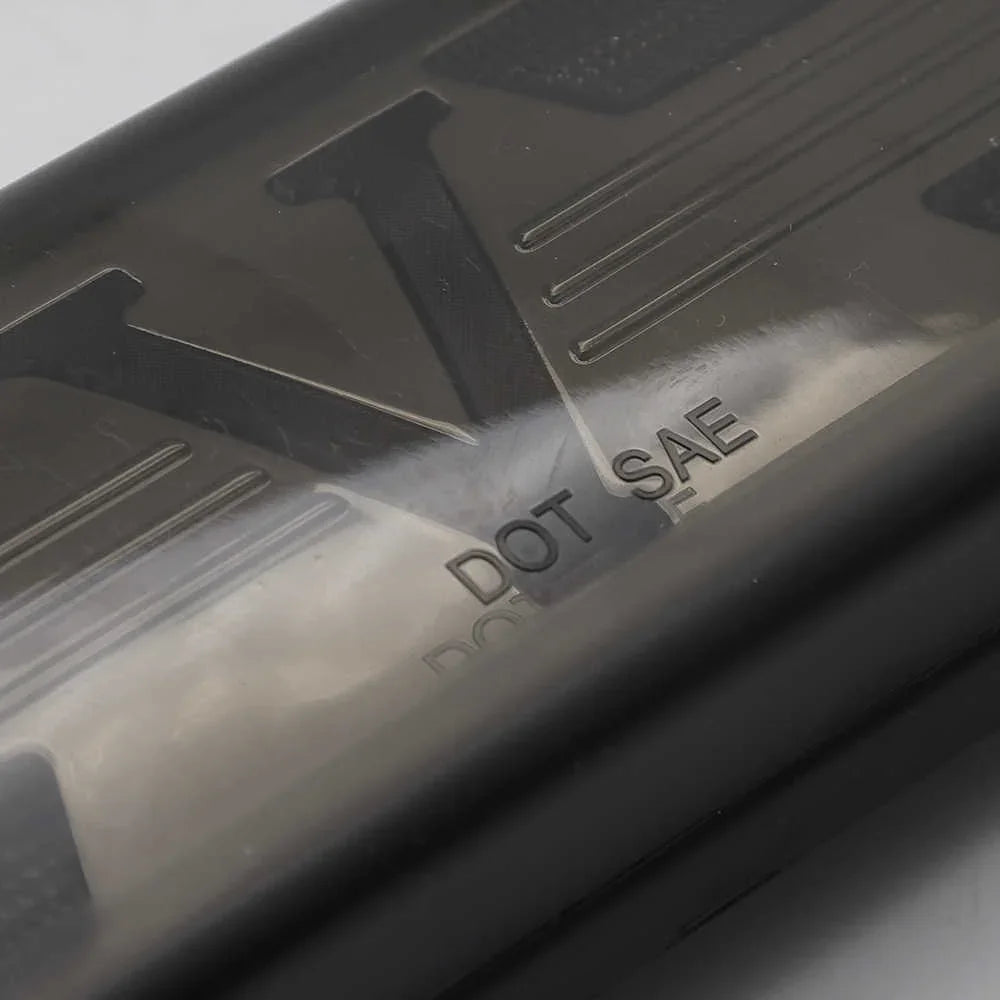 Close-up of a smoke 3rd brake light with 'DOT SAE' text on a gray background