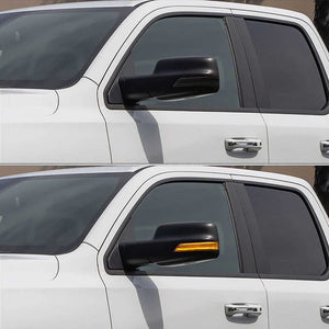 Side view of a white SUV with a side mirror cover on a blurred background
