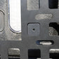 Close-up of a textured metal surface with a square hole