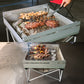 aluminum portable barbecue grill in use with steak, shrimp and lamb.
