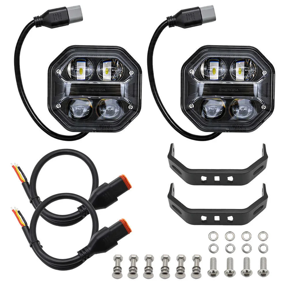 Two off-road vehicle lights with wiring harnesses and mounting brackets on a white background