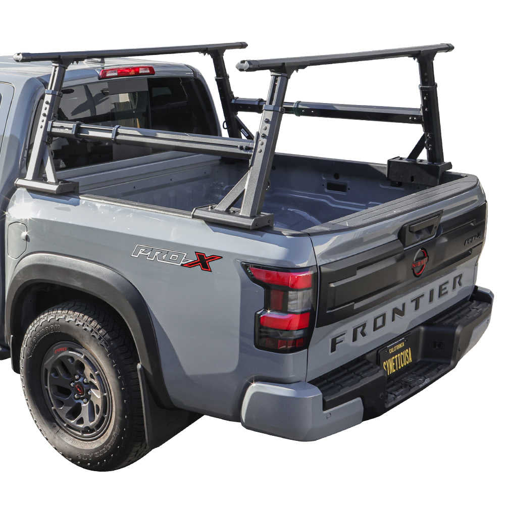 Gray Nissan Frontier truck with universal ladder rack on a white background