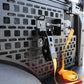 Close-up of a vehicle's cargo area with a black lattice design and an orange strap.