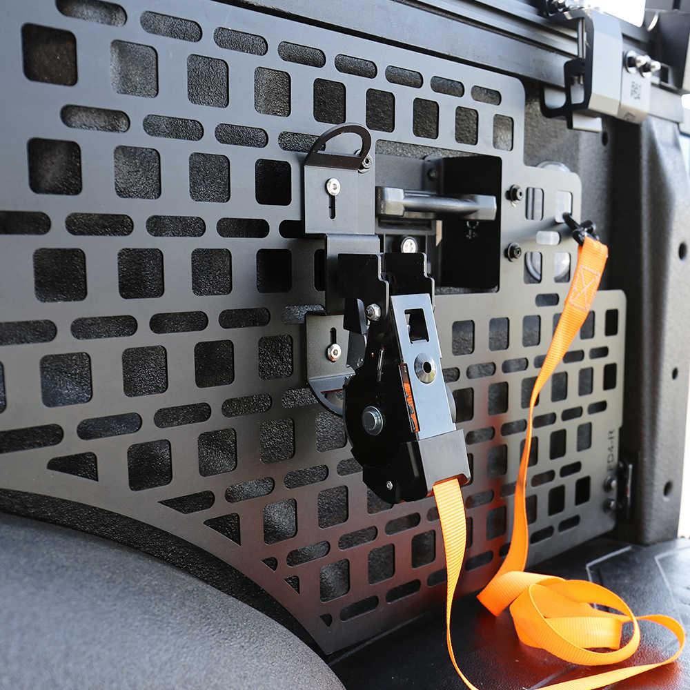 Close-up of a vehicle's cargo area with a black lattice design and an orange strap.