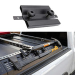 Black metal bracket on a white background with a truck bed rack in the foreground.