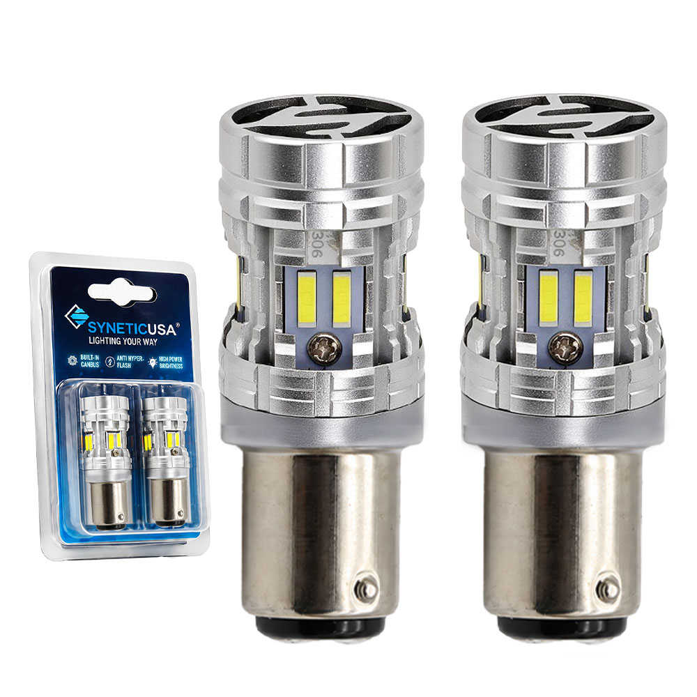 Two silver and black SYNETICUSA LED light 1157 bulbs shown next to their blue and white retail blister packaging on a white background.