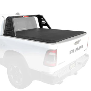 White RAM truck with a black soft roll-up tonneau cover and roll bar installed on a white background