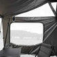 Camping tent interior with a view of mountains through the window