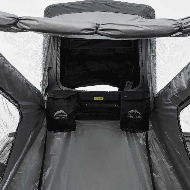 Backpacker tent interior with storage bags labeled 'Wild Land' on a clear background