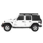 White Jeep Wrangler with a roof side awning on a white background