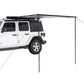 White SUV with a black side awning tent on a white background