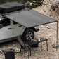 side awning installed on Jeep on a rocky environment