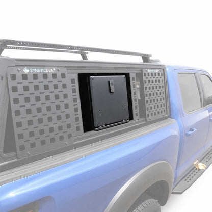 A blue pickup truck with a gray SYNETICUSA modular cap and storage compartment system, shown on a clean white background.