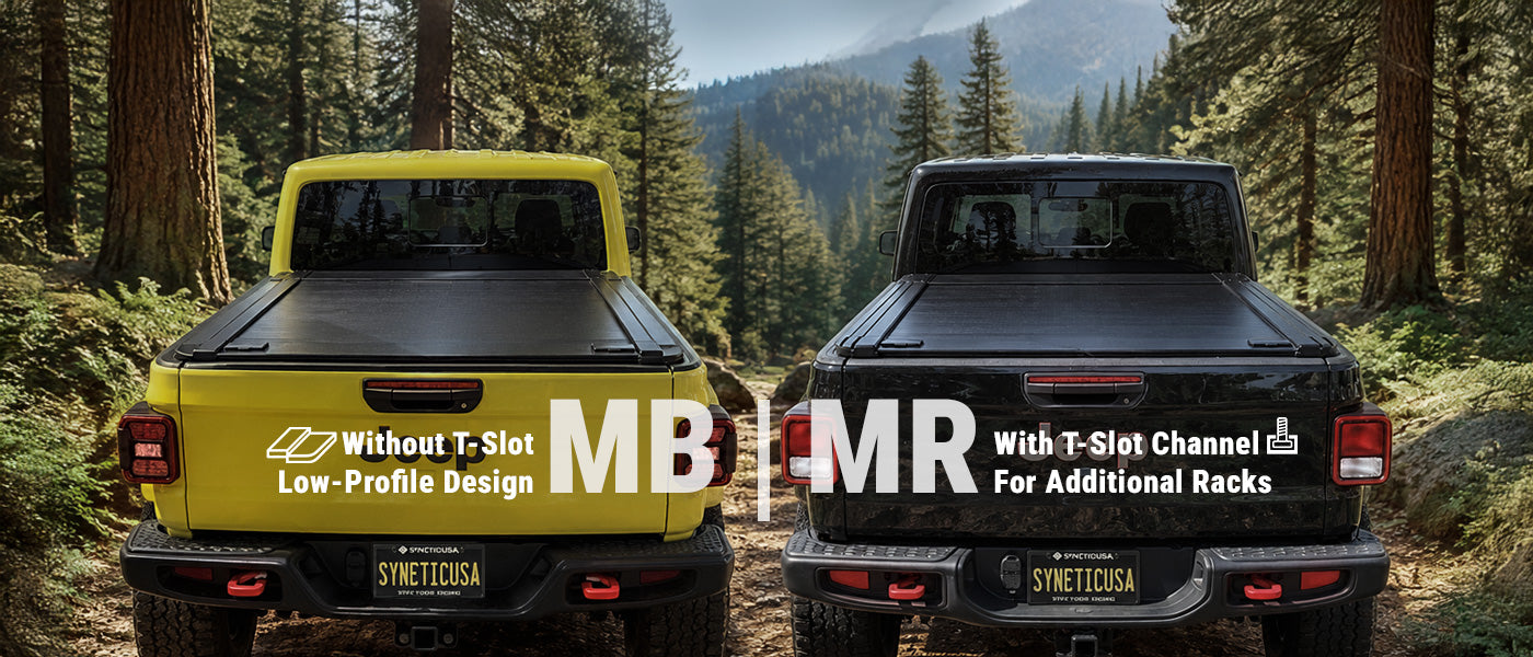 Two Jeep pickup trucks shown from the rear in a forest setting, one yellow and one black, with large overlaid text reading 'MB MR MANUAL RETRACTABLE'.