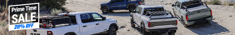 Four pickup trucks with bed covers in a desert setting, with a 'Prime Time Sale' banner on the left.