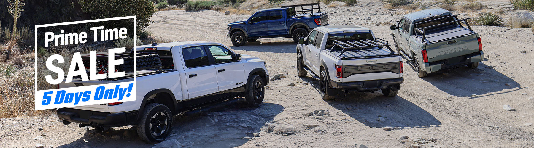 Three pickup trucks parked on a dirt road with 'Prime Time Sale' text overlay.