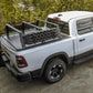 White pickup truck with a bed rack in a forested area