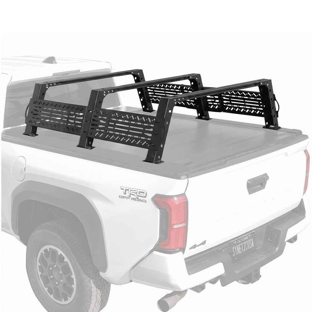 Black metal truck bed rack with slotted side panels mounted on the bed of a white pickup truck, shown against a plain white background.
