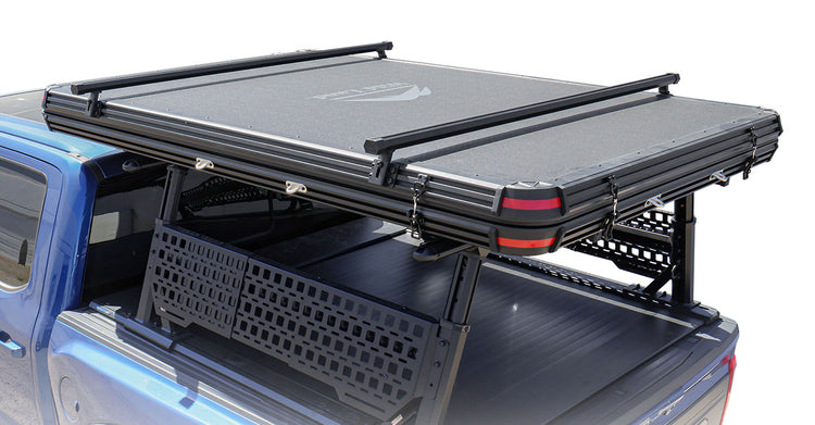 Roof top tent and rack system on a truck bed with a white background
