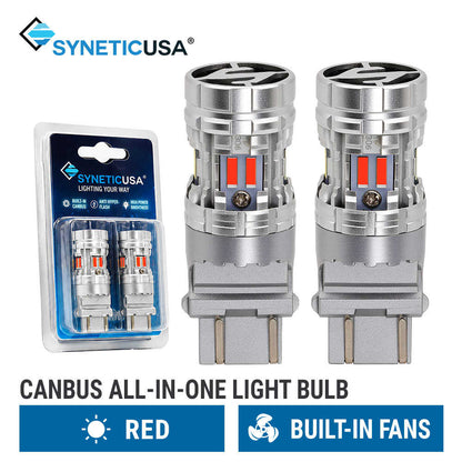 Two silver SyneticUSA canbus all-in-one 3157 light bulbs with built-in fans and red LED accents, shown alongside their blue retail blister packaging on a white background with product text overlays.