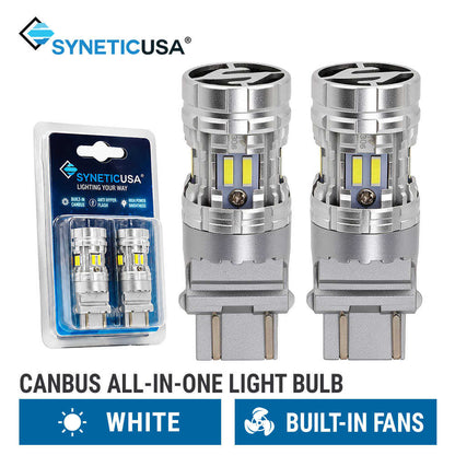 Two silver SyneticUSA canbus all-in-one LED 3157 3157CK light bulbs shown next to their blue retail blister packaging, with text indicating they are white and built-in fans.
