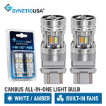 canbus all-in-one switchback LED light 3157 bulbs with built-in fans, shown alongside their blue and white retail blister packaging. The brand name 'SYNETICUSA' is visible at the top, and text at the bottom specifies 'CANBUS ALL-IN-ONE LIGHT BULB' with 'WHITE / AMBER' and 'BUILT-IN FANS'.