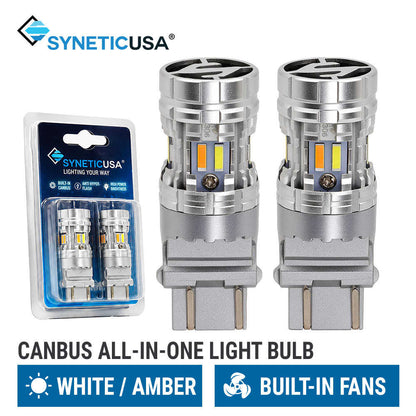 canbus all-in-one switchback LED light 3157 bulbs with built-in fans, shown alongside their blue and white retail blister packaging. The brand name 'SYNETICUSA' is visible at the top, and text at the bottom specifies 'CANBUS ALL-IN-ONE LIGHT BULB' with 'WHITE / AMBER' and 'BUILT-IN FANS'.