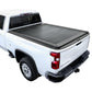 A black retractable tonneau cover installed on a white Chevrolet Silverado pickup truck.