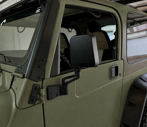 Close-up of a green off-road vehicle door with window and side mirror installed