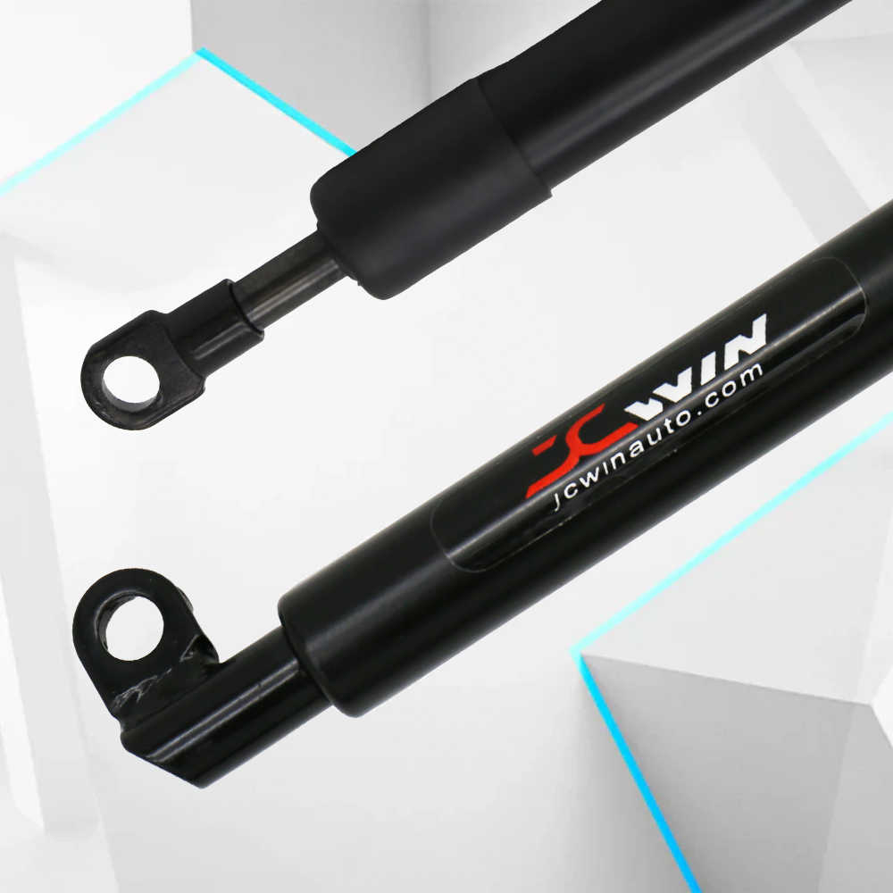 Two black shock absorbers with JCWin branding on a light gray background