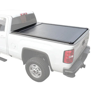A retractable tonneau cover made of aluminum and plastic, installed on the bed of a white pickup truck.