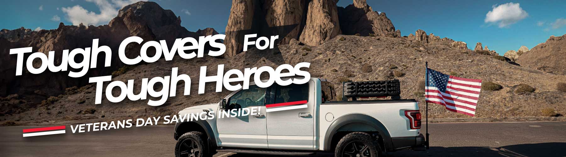 White truck with American flag on a desert landscape with text 'Tough Covers For Tough Heroes' and 'Veterans Day Savings Inside'.