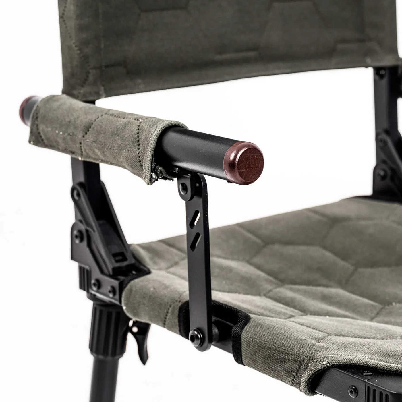 Close-up of a camping chair with quilted seat and armrest on a white background