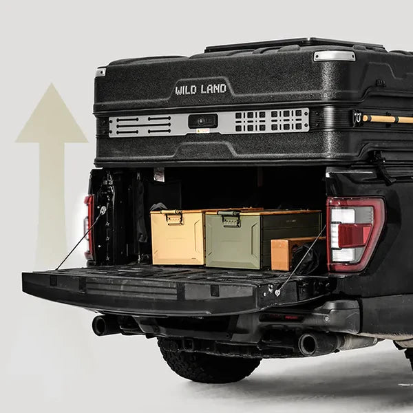 Truck bed with storage boxes and 'Wild Land' cargo management system on a light gray background