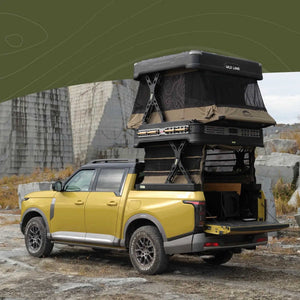 Yellow SUV with a WingmanX rooftop tent in a rocky outdoor setting