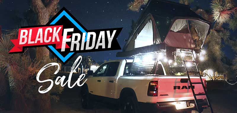 White truck with a roof tent at night, Black Friday sale text overlay