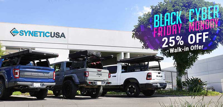 Three pickup trucks parked in front of a building with Synetic USA branding, featuring a Black Friday sale advertisement.