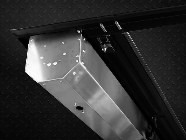 stainless steel canister on a vehicle with a black textured background