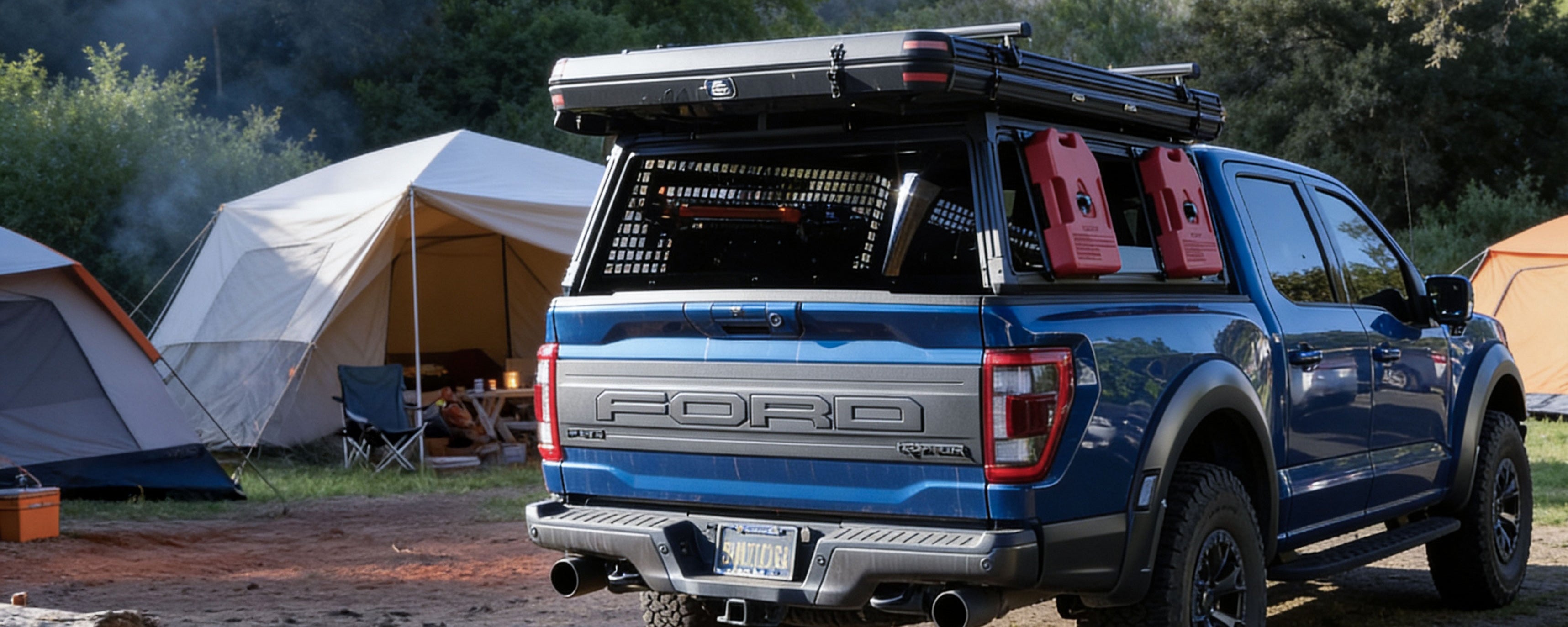 A blue Ford pickup truck with a roof-mounted tent and red jerry cans is parked outdoors at a campsite with tents and trees in the background.