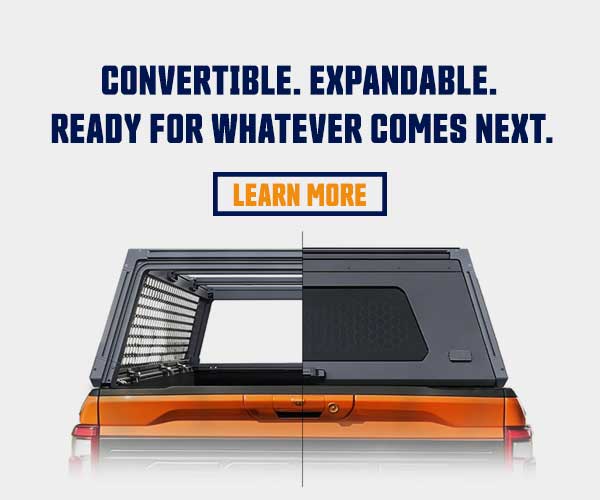 A black convertible truck bed cover installed on the bed of an orange pickup truck, shown against a white background with promotional text reading 'CONVERTIBLE. EXPANDABLE.