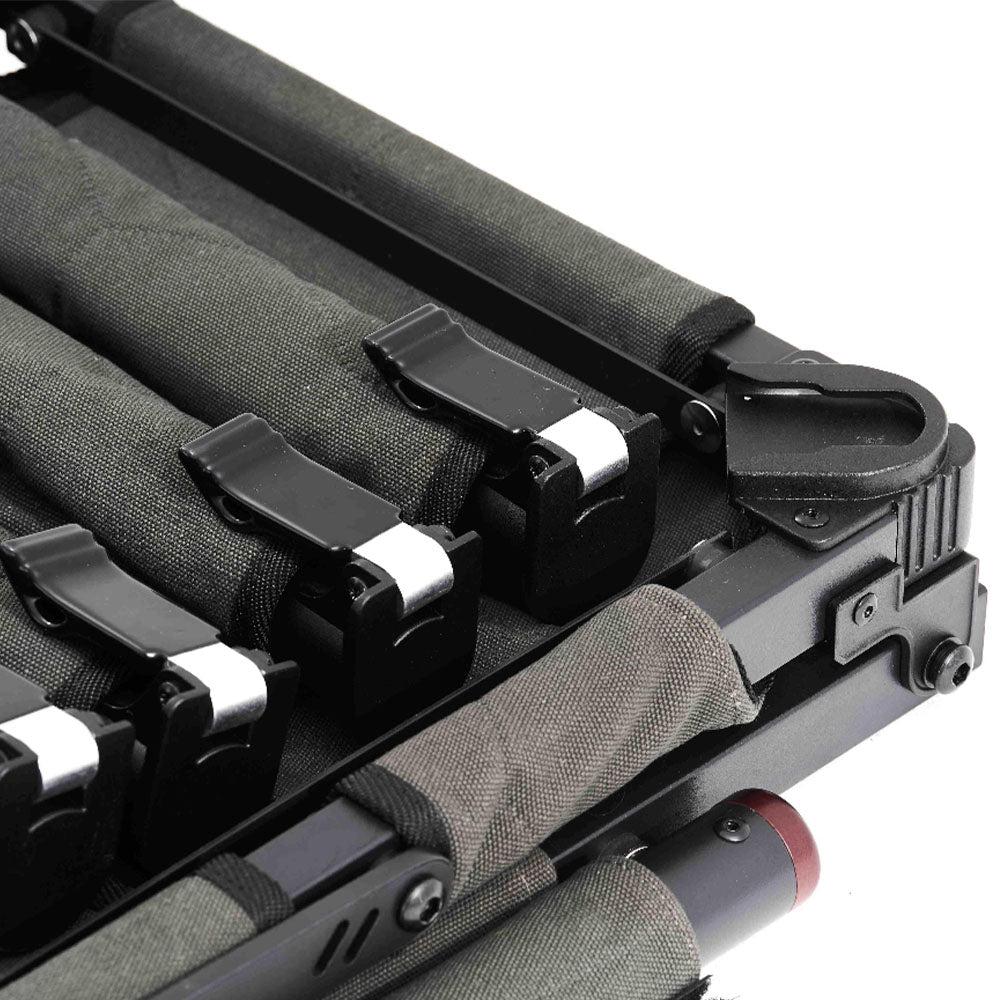 Close-up of a black metal and green fabric storage organizer with multiple.  