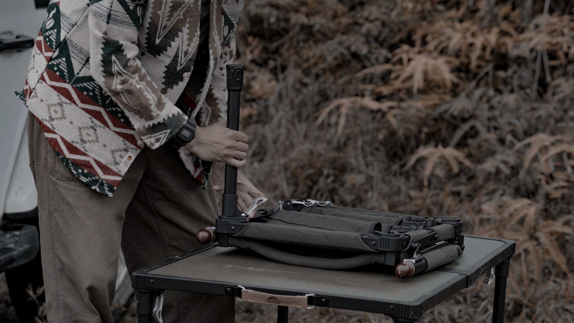 Person setting up mts-c chair on a table outdoors