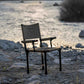 mts-c Chair on a rocky beach with water in the background