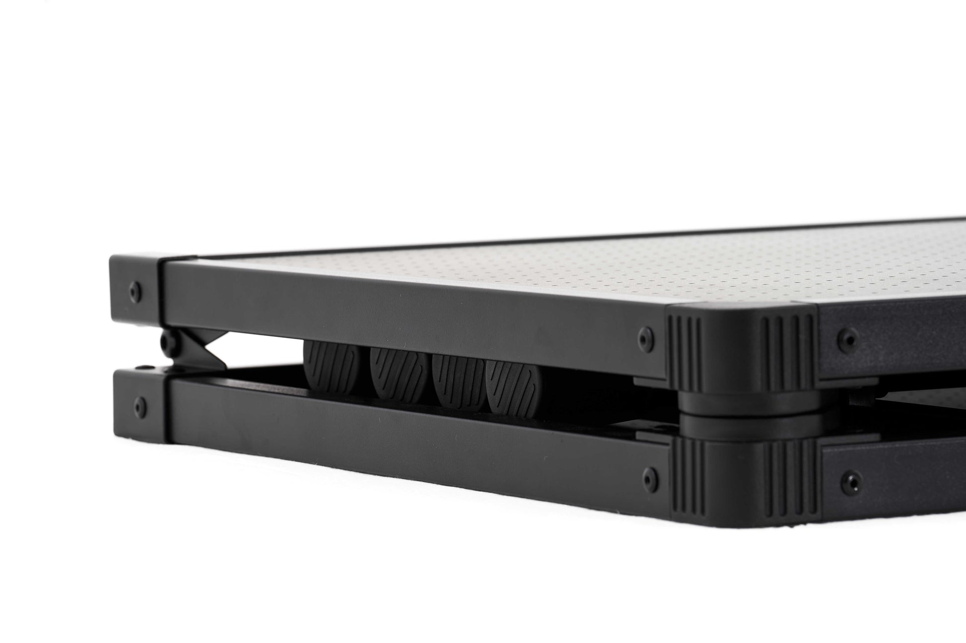 Close-up of a black metal frame with wheels on a white background
