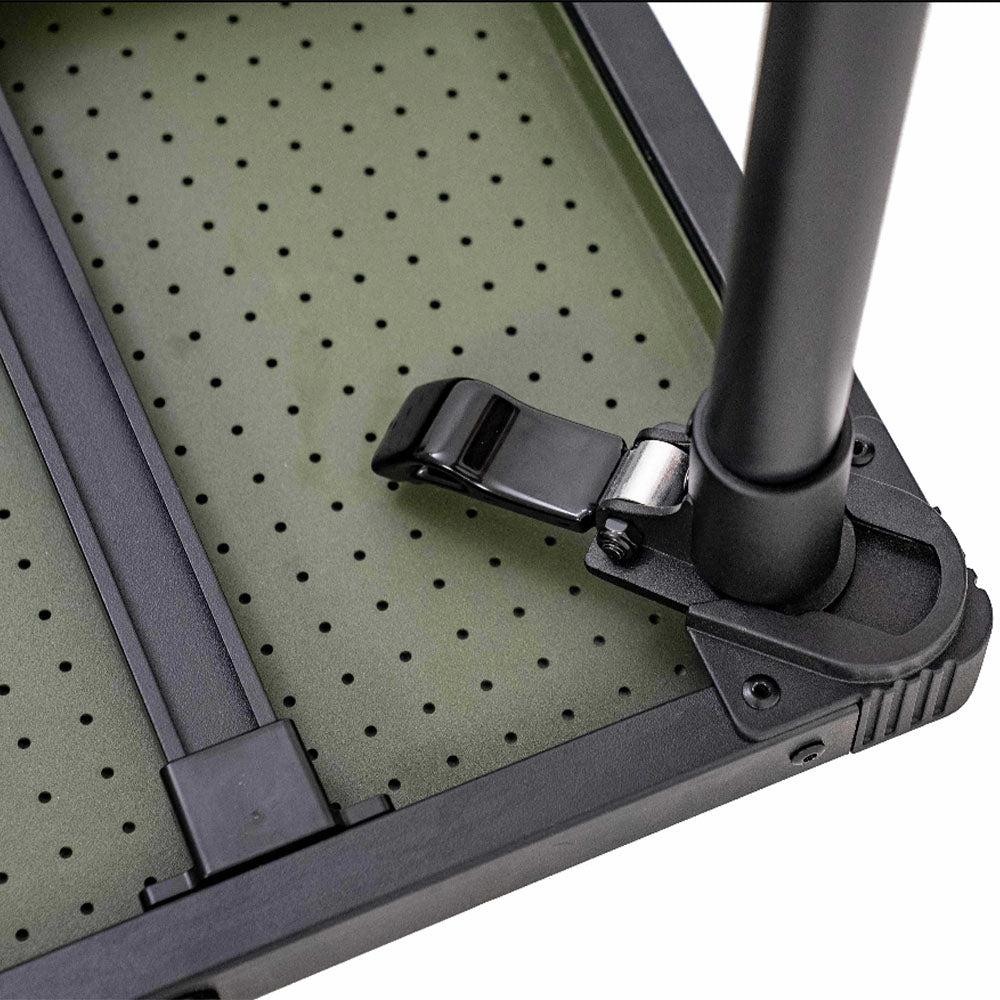 Close-up detail of a folding table showing a black metal leg clamp attached to a perforated olive green tabletop, on a white background.