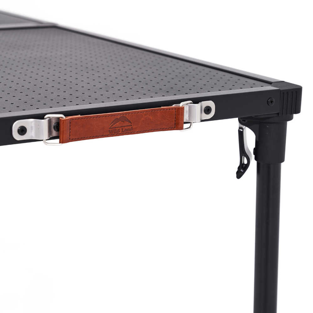 Close-up of a black metal table with a brown leather strap and table frame on a white background
