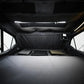 Dark interior of a orthframe with a bed setup and lighting fixtures.