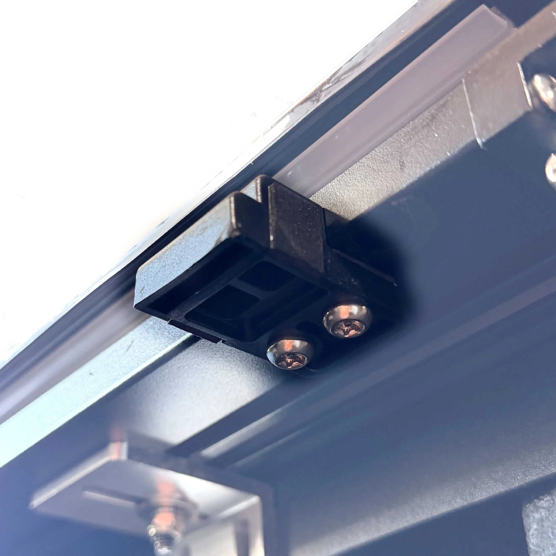 under view of a black plastic block, tonneau cover stopper