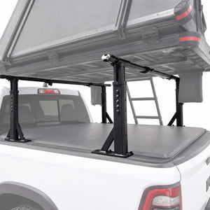 Black truck bed canopy rack system with a gray tonneau cover and ladder, mounted on a white pickup truck against a white studio background.